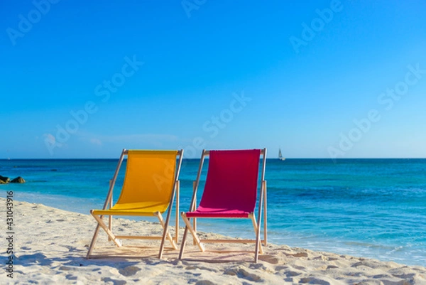 Fototapeta Colorful beach lounge chairs at the beach