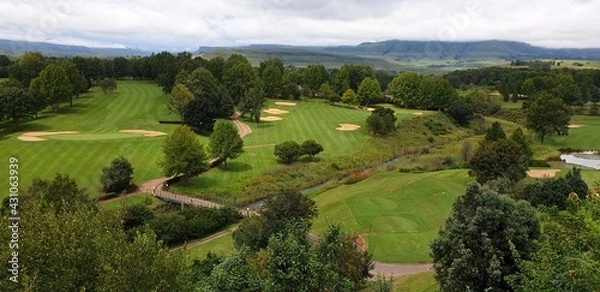 Fototapeta Golf course landscape with hills and sky