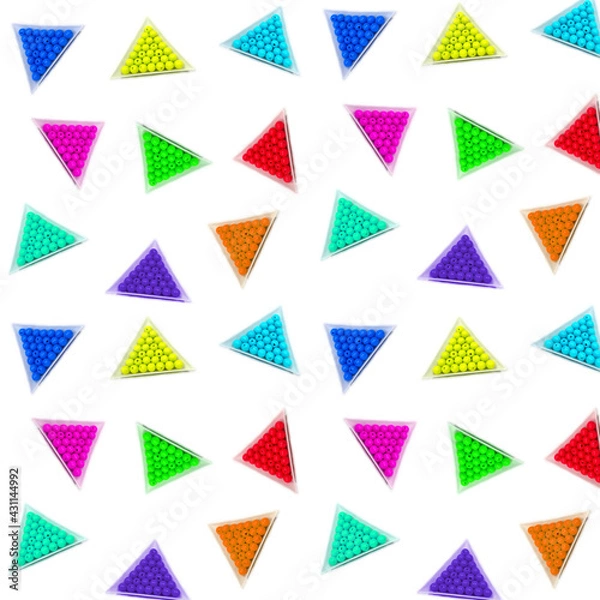 Fototapeta Seamless photo background of round acrylic colored beads in white triangular packages on a white background