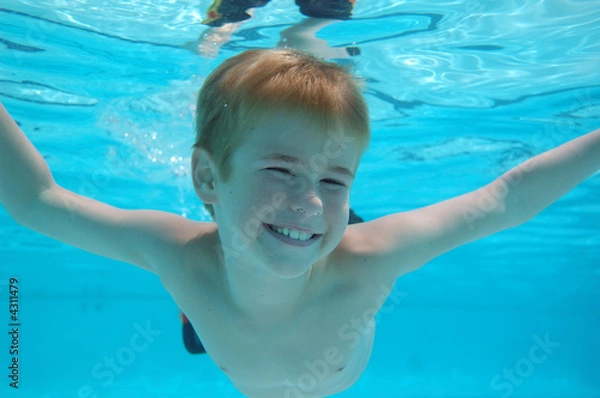 Fototapeta Boy swimming underwater