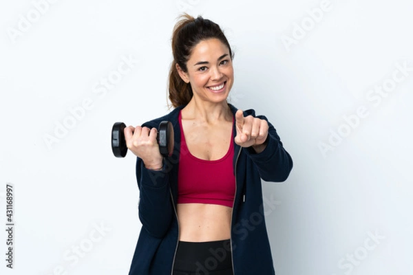 Obraz Sport woman making weightlifting over isolated white background points finger at you with a confident expression
