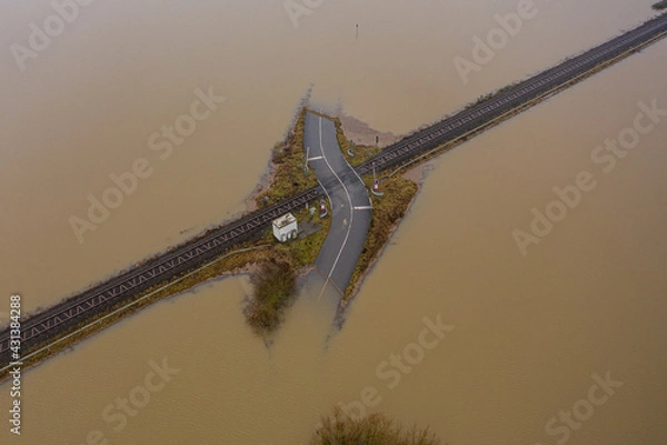 Obraz Flooded road passing through the railway. A road under water