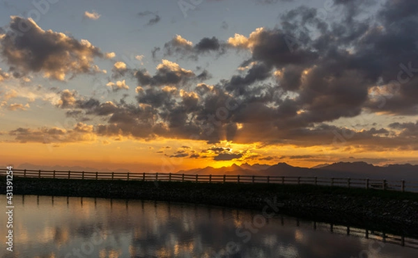 Fototapeta Sun rise in the beautiful tyrolean alps. In the foreground a beautiful mountain lake.