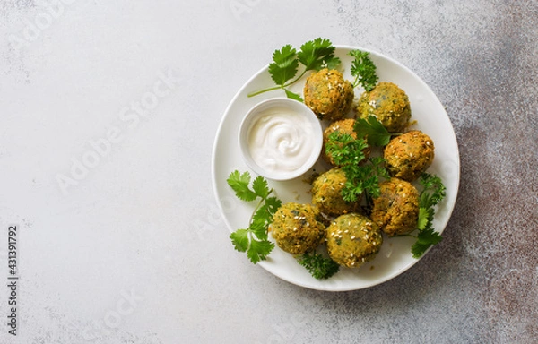 Obraz Homemade roasted falafel balls with greens and yogurt sauce