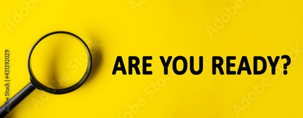 Fototapeta Text ARE YOU READY written over yellow background. Magnifying glass on yellow background. Minimal we are hiring background, job vacancy, business concept. question