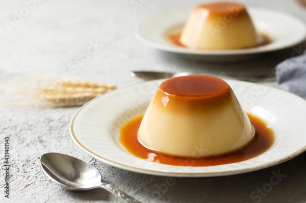 Fototapeta Cream caramel pudding with caramel sauce in plate on white rustic table