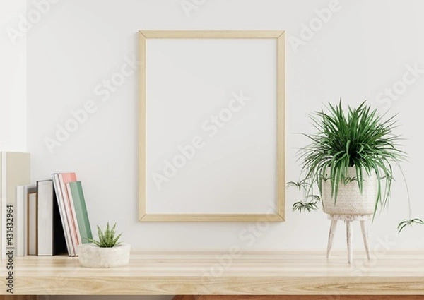 Obraz Photo frame mockup on a white wall in the living room, a flower pot and paper placed on a wooden table.3d rendering.