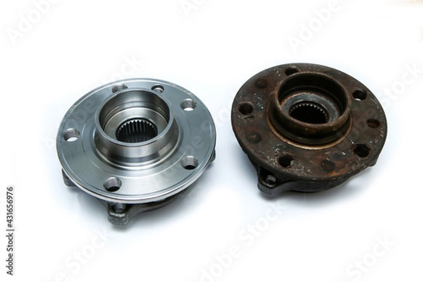 Fototapeta The comparison of the new shiny and  old rusty and broken car wheel bearings isolated on a white background. 