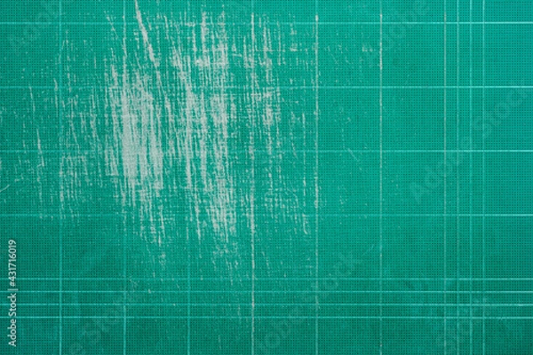 Fototapeta Old grunge green dirty cutting mat, grunge texture background,  top view, copy space for text and graphic.