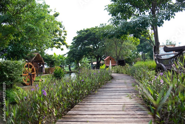 Obraz Old wooden bridge in a beautiful garden, springtime
