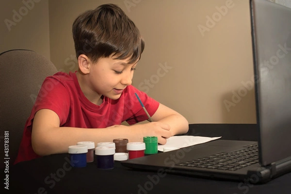 Obraz boy in an online paint drawing lesson. Children's creativity. Online School Distance Learning Concept