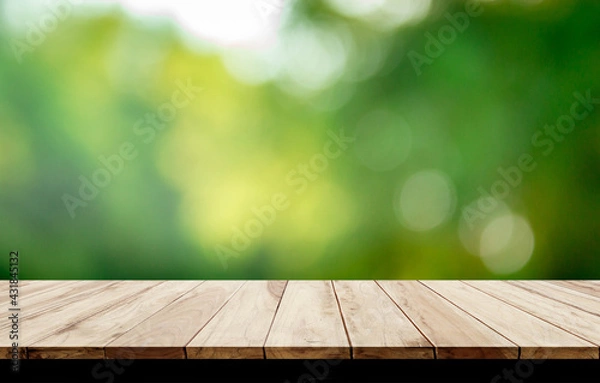 Fototapeta blurred background of green park in summer, Wood table top on shiny bokeh green background. For product display