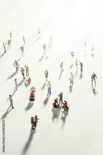 Fototapeta Top view of people (miniature toys) with long shadows keep distance away in public during sunrise or sunset.Social distancing during COVID-19 coronavirus outbreak spreading concept.