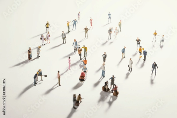 Fototapeta Top view of people (miniature toys) with long shadows keep distance away in public during sunrise or sunset.Social distancing during COVID-19 coronavirus outbreak spreading concept.