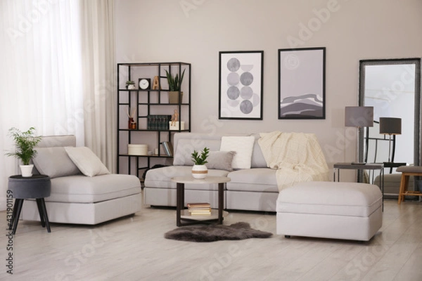 Fototapeta Stylish living room interior with comfortable sofa and large mirror