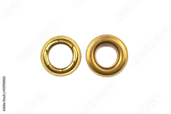 Fototapeta Catalogue photo of brass multicoloured metal eyelets or rivets - curtains rings for fastening fabric to the cornice, isolated on white background with copyspace for text. Selective focus