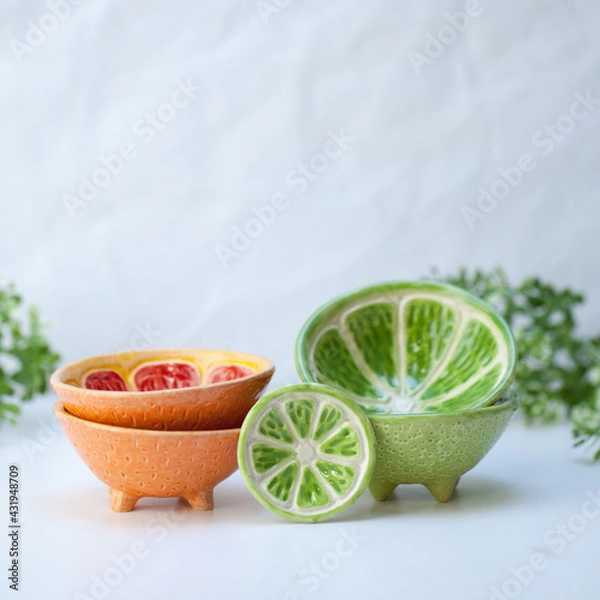 Fototapeta Ceramic cup in the form of half a lime.