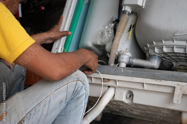 Obraz The technician is repairing the washing machine