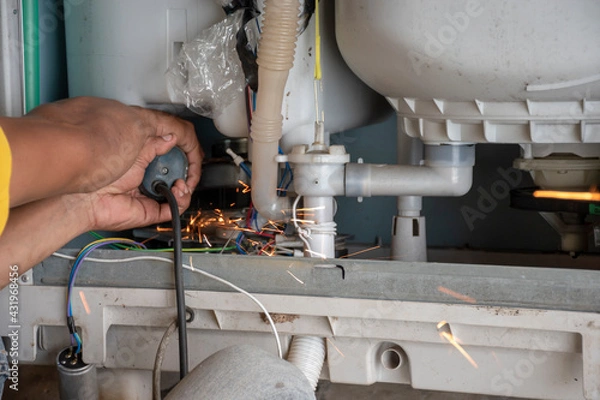 Obraz The technician is repairing the washing machine