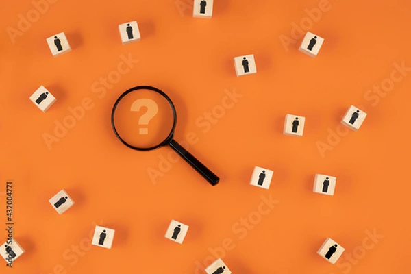 Fototapeta Search for talent or search for an employee concept using a magnifying glass and wooden cubes with human icons