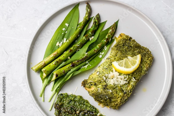 Fototapeta Salmon fillet with green wild garlic pesto. Green asparagus with salmon