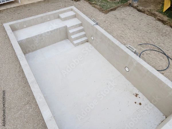 Obraz Drone photo of swimming pool in construction phase with gravel all around in a garden
