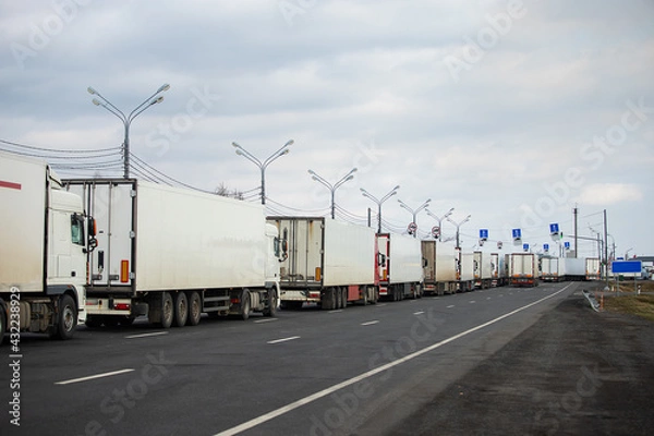 Fototapeta a long traffic jam of many trucks at the border , a long wait for customs checks between States due to the coronavirus epidemic, increased sanitary inspection of cargo transport