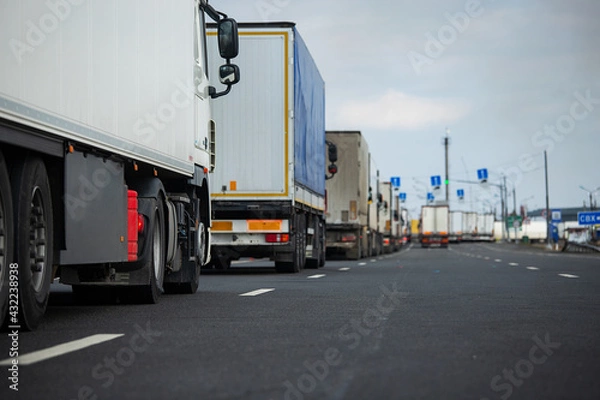 Fototapeta a long traffic jam of many trucks at the border , a long wait for customs checks between States due to the coronavirus epidemic, increased sanitary inspection of cargo transport