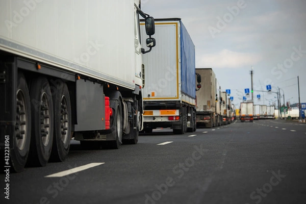 Fototapeta a long traffic jam of many trucks at the border , a long wait for customs checks between States due to the coronavirus epidemic, increased sanitary inspection of cargo transport