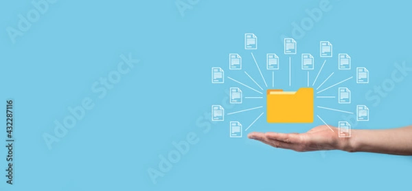 Obraz Document Management System (DMS).Businessman hold folder and document icon.Software for archiving, searching and managing corporate files and information.Internet Technology Concept.Digital security.