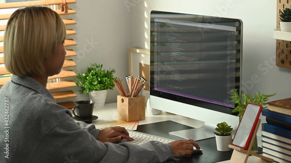 Fototapeta Side view young female programmers working on new project at the office.