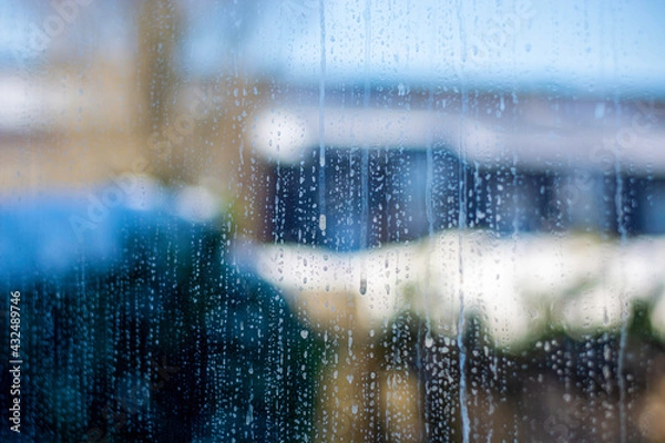 Fototapeta Close view of a distinctly dirty window glass showing grime, streaks and spots. Outside it is cold and it has snowed