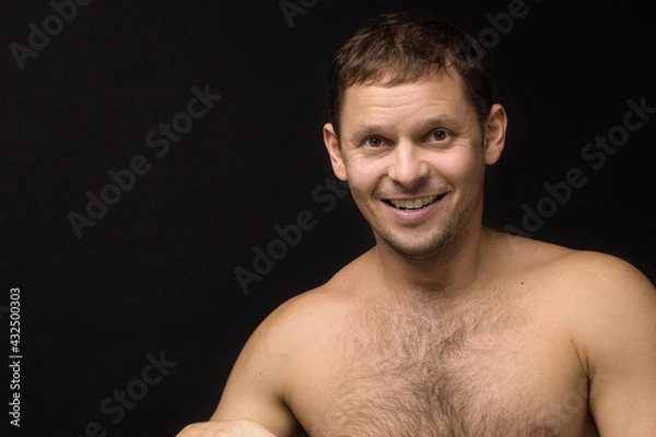 Obraz Handsome man on the black background. Muscular and athletic. Man portrait. Male model in studio	