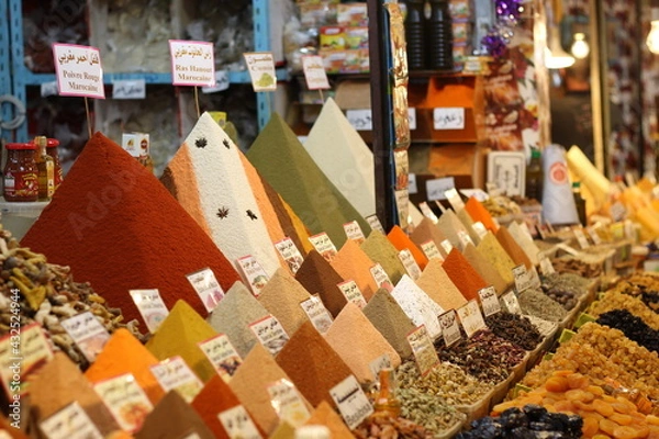 Fototapeta Spices pyramids and dry fruits in spice store of west algeria