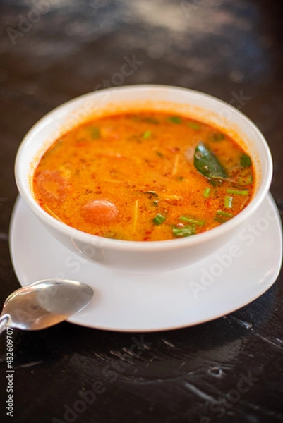 Obraz Tom Yam kung Spicy Thai soup with shrimp, seafood, coconut milk and chili pepper in bowl copy space