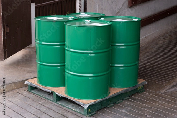Obraz Group of green color metal barrels on pallet waiting for transfer
