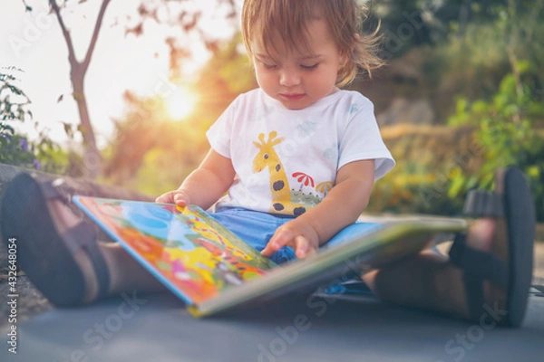 Obraz Little Boy with Book Outdoors