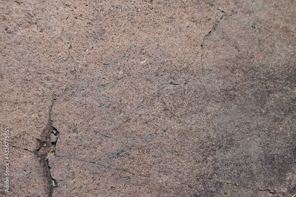 Fototapeta Brown andesite stone surface texture. Brown-grey rock with  cracks and cavities. Template for background