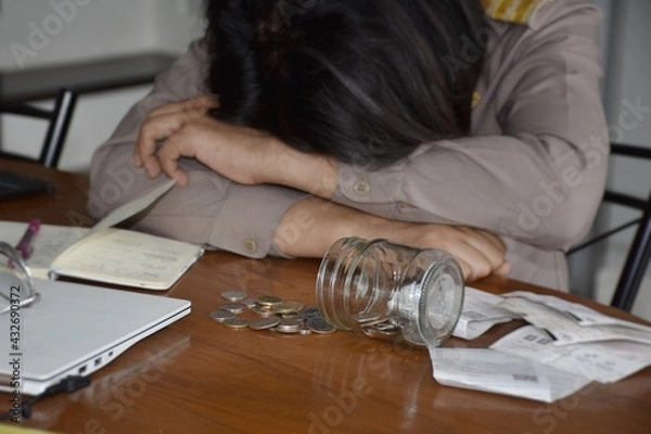 Fototapeta Thai government officials in uniform are stressed by lack of money, indicating the poor financial condition in the household.