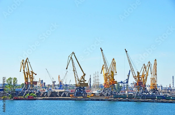 Fototapeta Pipe stack, ready for shipping under cargo crane