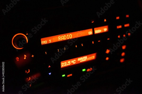 Obraz Modern car radio illuminated with orange color
