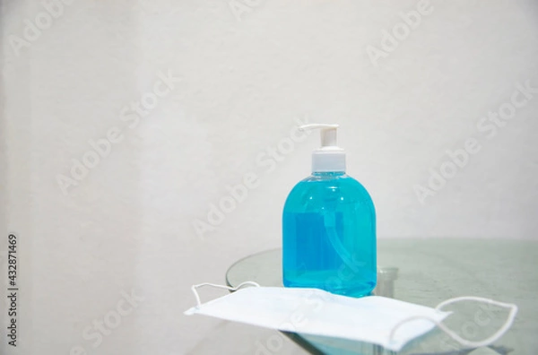 Obraz Coronavirus prevention hand sanitizer gel and protection face mask.