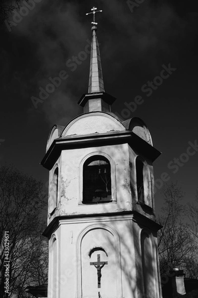 Fototapeta crucifix on the wall of the bell tower of the christian temple, in black and white
