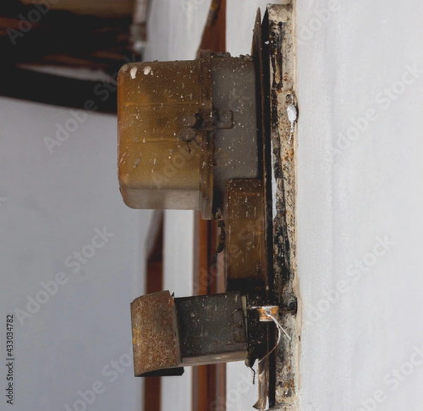 Fototapeta the electric meter pinned to the wall. to control electricity in the house. as a central source of electricity in the house.