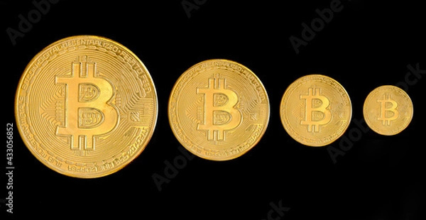 Fototapeta Bitcoin falling down concept isolated on black background. Golden bitcoin price declining conceptual photography. Step by step.