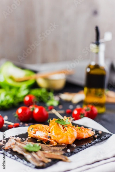 Fototapeta anchovy and shrimp with tomato and fresh herbs