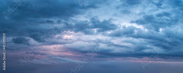 Obraz Dramatic overcast sky at evening panoramic shot. Scenic blue gray clouds before the storm. Scenic cloudscape before the rain. Blue hour stormy cloudscape. Dark thunderstorm sky wide image.