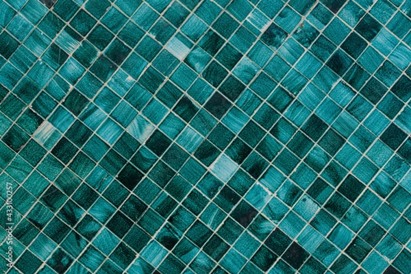 Fototapeta Minimalist textured monochrome background of old green teal mosaic tiles in horizontal display.