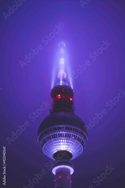 Obraz Scenic View Famous Alexanderplatz TV Tower of Berlin, Germany in Modern Futuristic Purple Light Color surrounded by Fog at Night, Close up View of Antenna