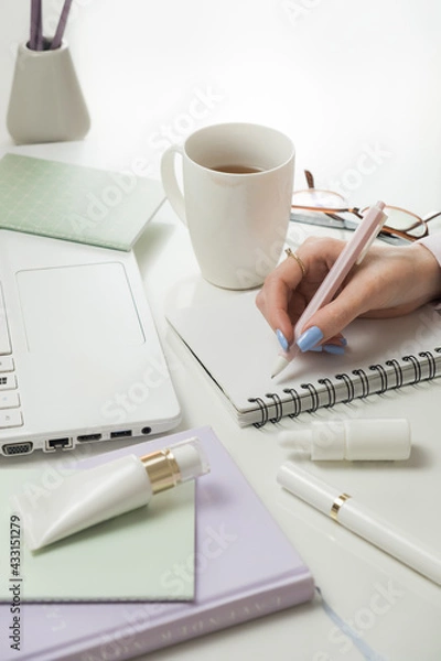 Obraz Female hands working on laptop and accessories. Office white desktop, flat lay. Remote working from home. Freelancers laptop, cup of coffee, spectacles. Concept of distance learning, isolation, female